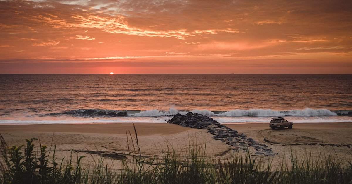 Sunrise on a Delaware beach with beach patrol on duty