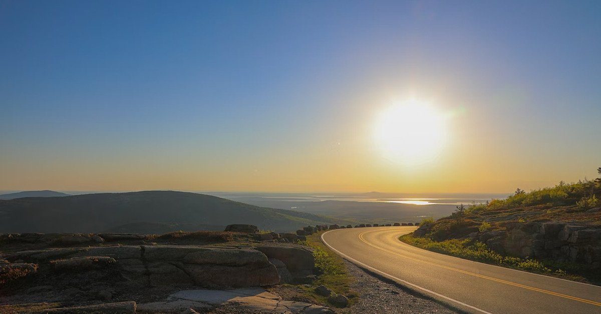 Maine highway with sunset in the background