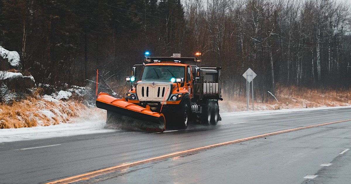 Snow plow on minnesota highway reminds us to check our Car Insurance coverages.