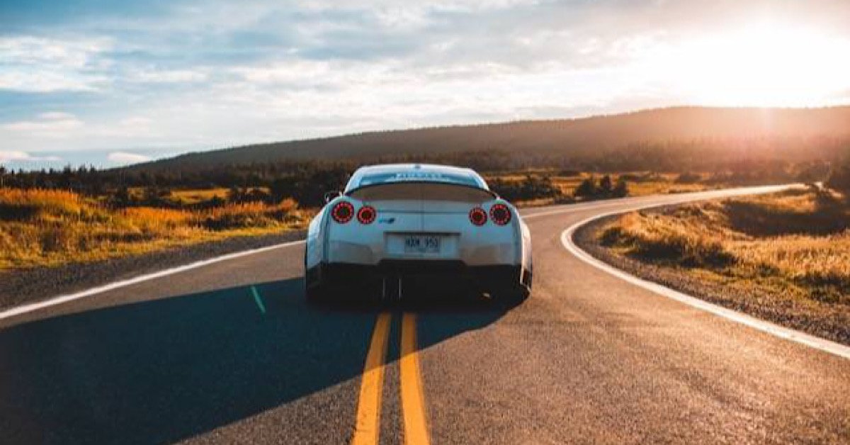 Full coverage car insurance, car driving off into sunset