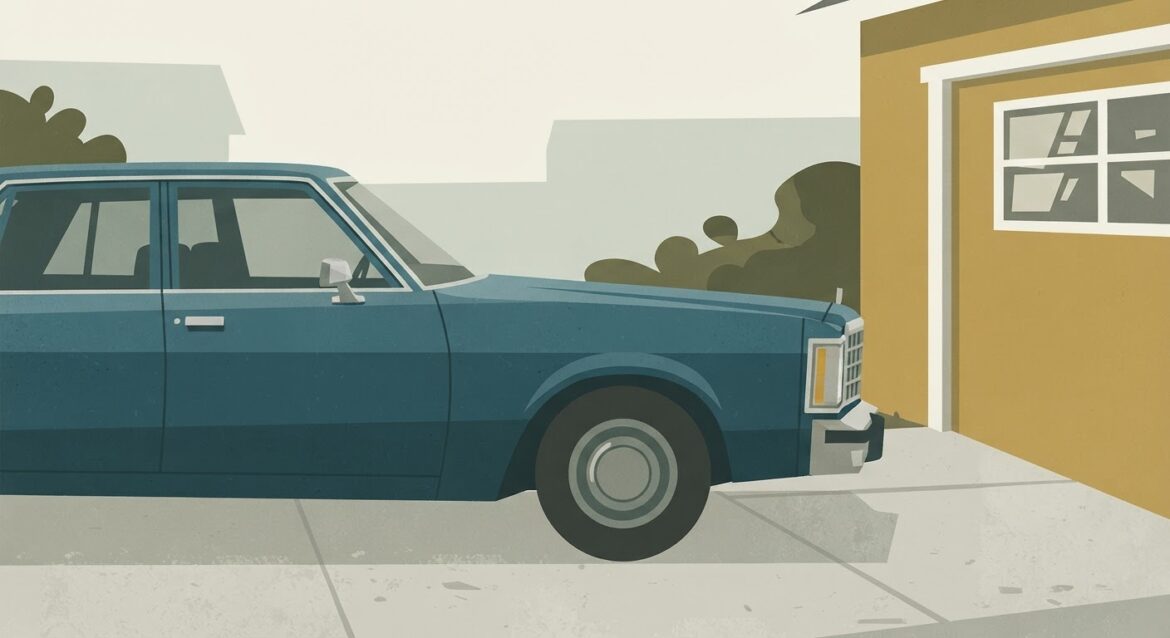 an older sedan parked in a driveway